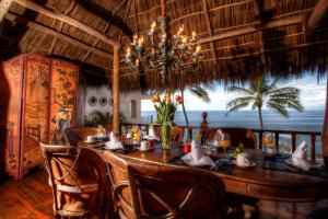 a dining room with a table and a chandelier at Quinta Maria Cortez in Puerto Vallarta
