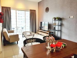 a living room with a wooden table and a dining room at No.2 The Loft @Puchong Skypod Residence in Puchong