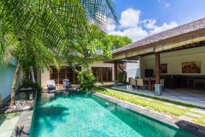 a swimming pool in the backyard of a villa at VILLA AISHA in Sanur