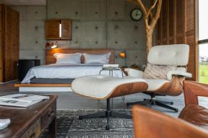 a bedroom with a bed and a chair and a desk at 呆宅Just Stay in Dongshan