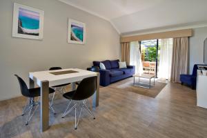 a living room with a table and chairs and a couch at Vintages Accommodation in Margaret River Town