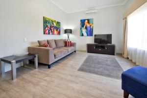 a living room with a couch and a tv at Vintages Accommodation in Margaret River Town