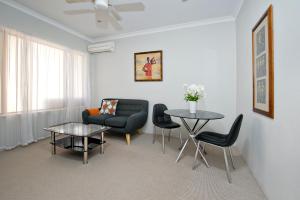 a living room filled with furniture and a table at Vintages Accommodation in Margaret River Town