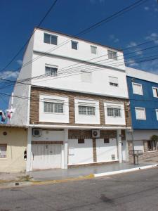 a white building on the side of a street at MarWal Departamentos in Santa Teresita