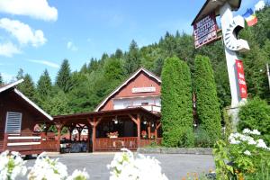 a restaurant with a sign in front of a building at Motel Cristina in Bicaz