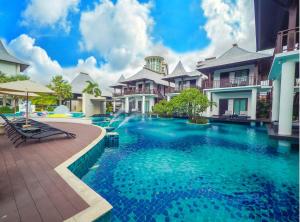 a swimming pool in front of some houses at Z Through By The Zign in North Pattaya