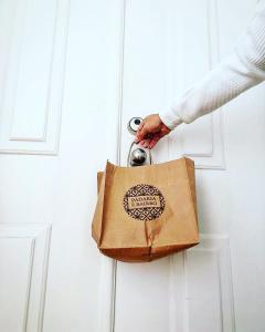 a person holding a brown bag on a door at Best apartment in Baixa-Chiado in Lisbon