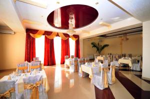 a banquet hall with white tables and chairs at Chervona Gora in Mukacheve