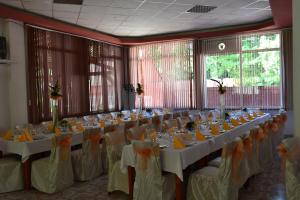 a large banquet room with tables and chairs at Motel Cristina in Bicaz