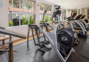 a gym with several treadmills and elliptical machines at Best Western Nairobi Upper Hill in Nairobi
