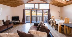 a living room with a couch and a table at Lodge 9 Glengoulandie Lodges in Aberfeldy