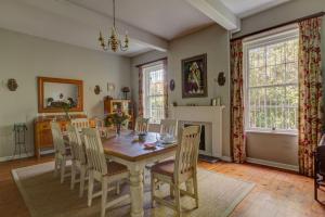 a dining room with a table and chairs at Sandown Lodge in Cape Town