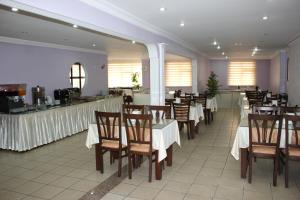 a dining room with tables and chairs in a restaurant at Nazar Hotel in Trabzon +31 photos