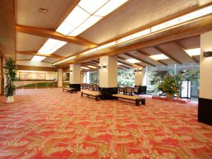 a large lobby with a large rug on the floor at Yumoto Kanko Hotel Saikyo in Nagato
