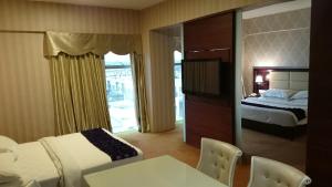 Postel nebo postele na pokoji v ubytování Pariss Hotel