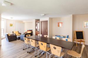 a living room with a large table and chairs at Résidence Pierre & Vacances Les Citronniers in Menton