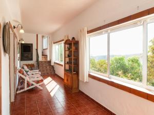 a living room with a large window and a staircase at Rural Village Salobre in Maspalomas