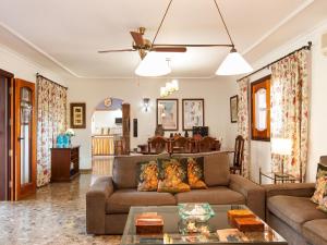 a living room with a couch and a table at Rural Village Salobre by VillaGranCanaria in Maspalomas +32 photos
