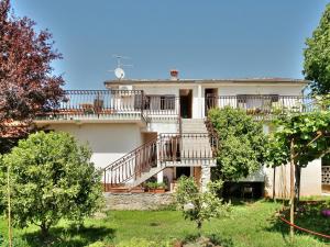 a large house with a staircase in a yard at PARADINOVIC house with apartments in Zambratija
