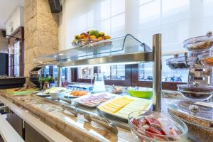 a buffet line in a restaurant with food at Apartamentos Orosol 2 by Typic Hotels in San Antonio