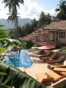 ein Resort mit einem Swimmingpool mit Stühlen und Sonnenschirmen in der Unterkunft Khanom Hill Resort in Khanom