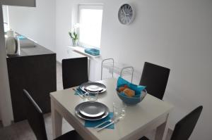 a table with a bowl of food on top of it at Studio nad Jeziorem in Poznań