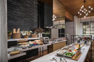 a kitchen with a buffet of food on display at Somerset Sukhumvit Thonglor Bangkok in Bangkok