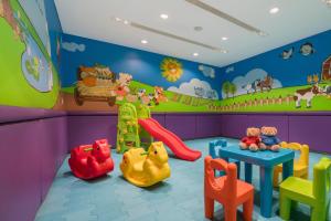 a childrens play room with a slide and play equipment at Somerset Sukhumvit Thonglor Bangkok in Bangkok