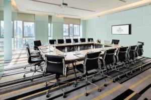 a large conference room with a long table and chairs at Somerset Sukhumvit Thonglor in Bangkok