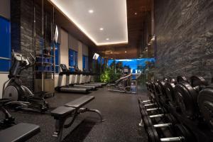 a gym with rows of chairs and machines at Somerset Sukhumvit Thonglor in Bangkok