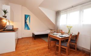 a kitchen and a dining room with a table and chairs at Císařka Apartment in Prague