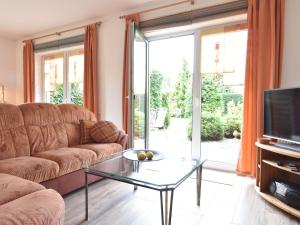 a living room with a couch and a glass table at Comfortable Apartment in Kuhlungsborn Near Sea in Kühlungsborn