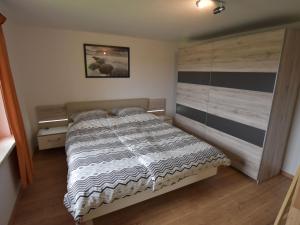 een slaapkamer met een groot bed met een houten hoofdeinde bij Luxurious Villa in Nadrin Belgium with Sauna and Jacuzzi in Blowatz