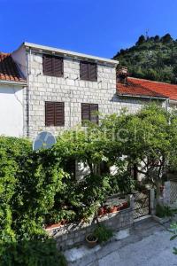 a stone building with trees in front of it at Ante Apartments in Trstenik