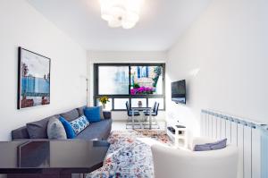 a living room with a couch and a table at Colony Suites - Hildesheimer St. in Jerusalem