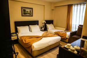 Postel nebo postele na pokoji v ubytování Canakkale Bogaz Hotel