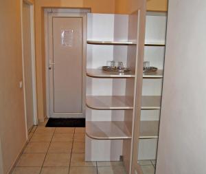 a hallway with white shelves in a room at Kambarių nuoma - Šiauliai SAURIDA in Šiauliai