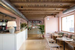 a restaurant with tables and chairs and a bar at Hostal la Savina in La Savina