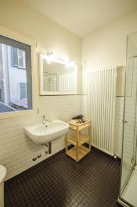a bathroom with a sink and a mirror at Azeglio apartment, a due passi da Piazza Maggiore in Bologna +37 photos