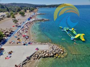 an aerial view of a beach with a water slide at Apartments Violete 742 in Pula