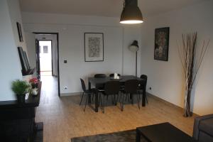 a dining room with a black table and chairs at Baleal Holidays - Baleal Beach front-Malibu Connection in Baleal