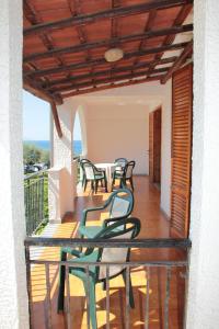a balcony with a table and chairs on it at Residence L'uliveto in Gioiosa Marea