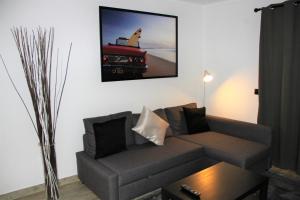 a living room with a couch and a picture of a truck at Baleal Holidays - Baleal Beach front-Malibu Connection in Baleal