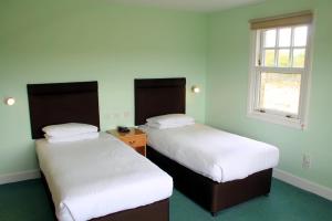 A bed or beds in a room at Drumoig Golf Hotel 