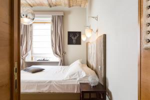a bedroom with a bed and a window at Rooms Roma - Monti in Rome