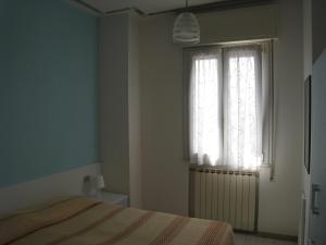 A bed or beds in a room at Appartamento Adriatico