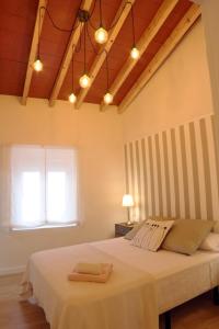 a bedroom with a large white bed with a window at APLUS Apartamentos, Old Town Benidorm in Benidorm