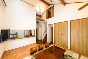 ein Wohnzimmer mit einem Tisch und Holzschränken in der Unterkunft Guest Villa Hakone Yumoto 201 in Hakone