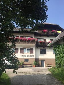 a building with flowers on the balconies of it at Haus Binder in Weissensee