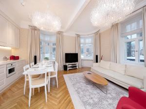 a living room with a white couch and a table at Harju Old Town Apartment in Tallinn